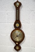 A 19th century mahogany wheel barometer, with hygrometer, thermometer, mirror, spirit level,
