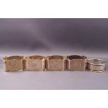 A set of four silver engine turned oblong napkin rings,