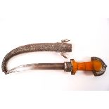 A Middle Eastern curved dagger in decorative white metal scabbard