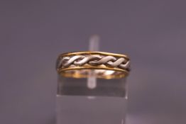 A yellow and white metal twisted band ring. Size N. Hallmarked mixed metal 18ct and platinum, B&N 3.