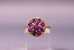 A yellow metal dress ring set with amethysts. Hallmarked 9ct gold. Size M.3.