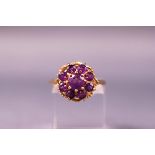 A yellow metal dress ring set with amethysts. Hallmarked 9ct gold. Size M.3.