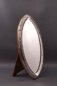 An oval silver frame, with additional mirror glass on easel stand, overall 21cm high x 11cm,