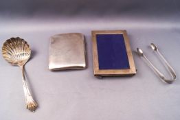 A silver cigarette case, Birmingham 1944, a small silver pair of sugar tongs, London 1871,