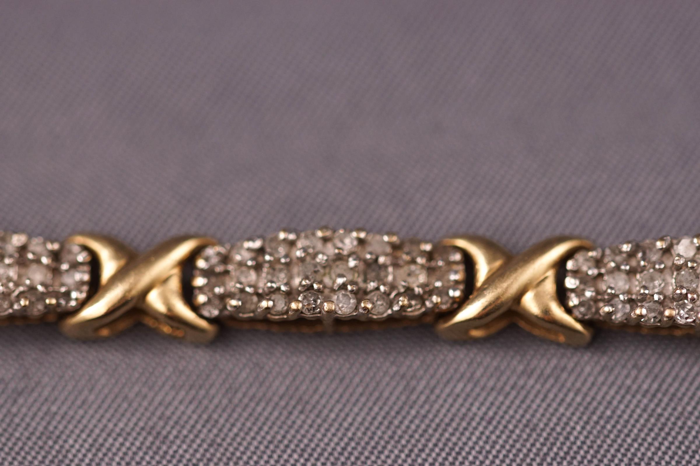 A yellow and white metal diamond bracelet set with round brilliant cut diamonds estimated to be 3. - Image 2 of 3