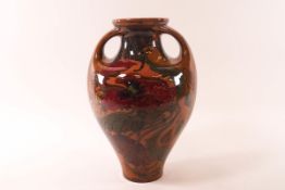 A terracotta art nouveau two handled vase painted with poppies indistinctly marked,