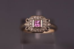 A white metal cluster ring set with a square pink sapphire and surrounded by diamonds.