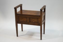 An oak piano stool with double panelled front on square tapering legs,