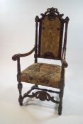 A 19th century beech and mahogany armchair with carved scroll and shell crest rail, scroll arms,