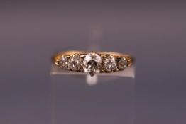 A late Victorian gold and diamond five stone carved half hoop ring with rose diamond points,