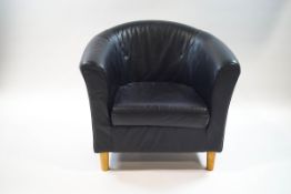 A black leatherette tub shaped chair,