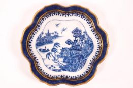 A late 18th century Caughley porcelain teapot stand printed in blue with a Chinoisere scene,