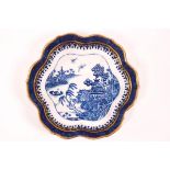 A late 18th century Caughley porcelain teapot stand printed in blue with a Chinoisere scene,