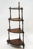 A Victorian walnut corner whatnot with four waterfall ties on turned legs,