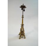 A 19th century plated brass altar type twin candlestick, adapted for electricity,