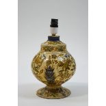 A Kashmire papier mache table lamp painted with birds and flowers on a cream ground,