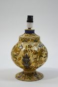 A Kashmire papier mache table lamp painted with birds and flowers on a cream ground,