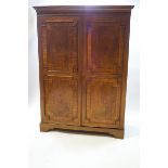 A 19th century mahogany double wardrobe with geometric moulding and crossbanding,