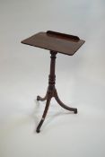 A Regency mahogany reading table on turned column and outswept legs,