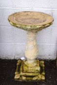 A re-constituted stone garden bird bath,