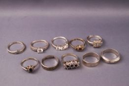 A white metal and single stone ring and a white metal wishbone ring, both marked 925,