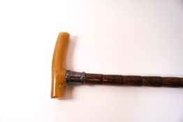 A late Victorian bamboo walking cane with horn handle and silver collar,