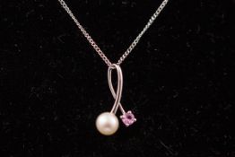 A white metal pendant set with a clultured pearl and pink sapphire.