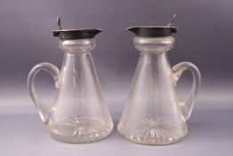 A pair of silver mounted conical glass whiskey noggins, Birmingham 1906-07 by Hukin & Heath,
