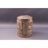 An Indian white metal box and cover, embossed with various animals,