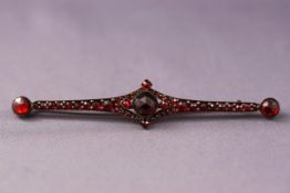 A 19th century gold and Bohemian garnet cluster bar brooch, 8.5cm long overall 5.