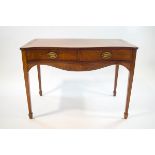 A 19th century mahogany side table with cross banding and serpentine front above two drawers on