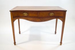 A 19th century mahogany side table with cross banding and serpentine front above two drawers on
