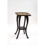 An aesthetic movement two tier table carved overall with flower heads,