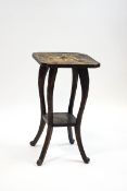 An aesthetic movement two tier table carved overall with flower heads,