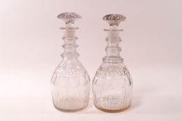 A pair of 19th century cut glass triple ring necked decanters and stoppers, 21.