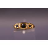 A yellow metal half hoop ring set with sapphires and old cut diamonds. Hallmarked 18ct gold. Size K.