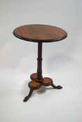 A George III style mahogany tripod table on claw and ball feet