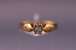 A yellow metal ring set with a single diamond and diamond shoulders. Hallmarked 9ct gold. Size: O.