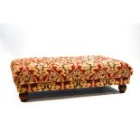 A rectangular footstool with button upholstered top and reeded feet,