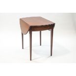 An Edwardian mahogany Pembroke table with stringing and single drawer on square tapering legs,