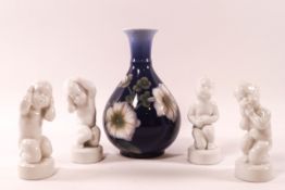 A set of four Bing and Grondahl blanc de chine porcelain figures of boys,