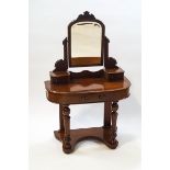 A Victorian mahogany dressing table with swing frame mirror and three drawers on turned front legs