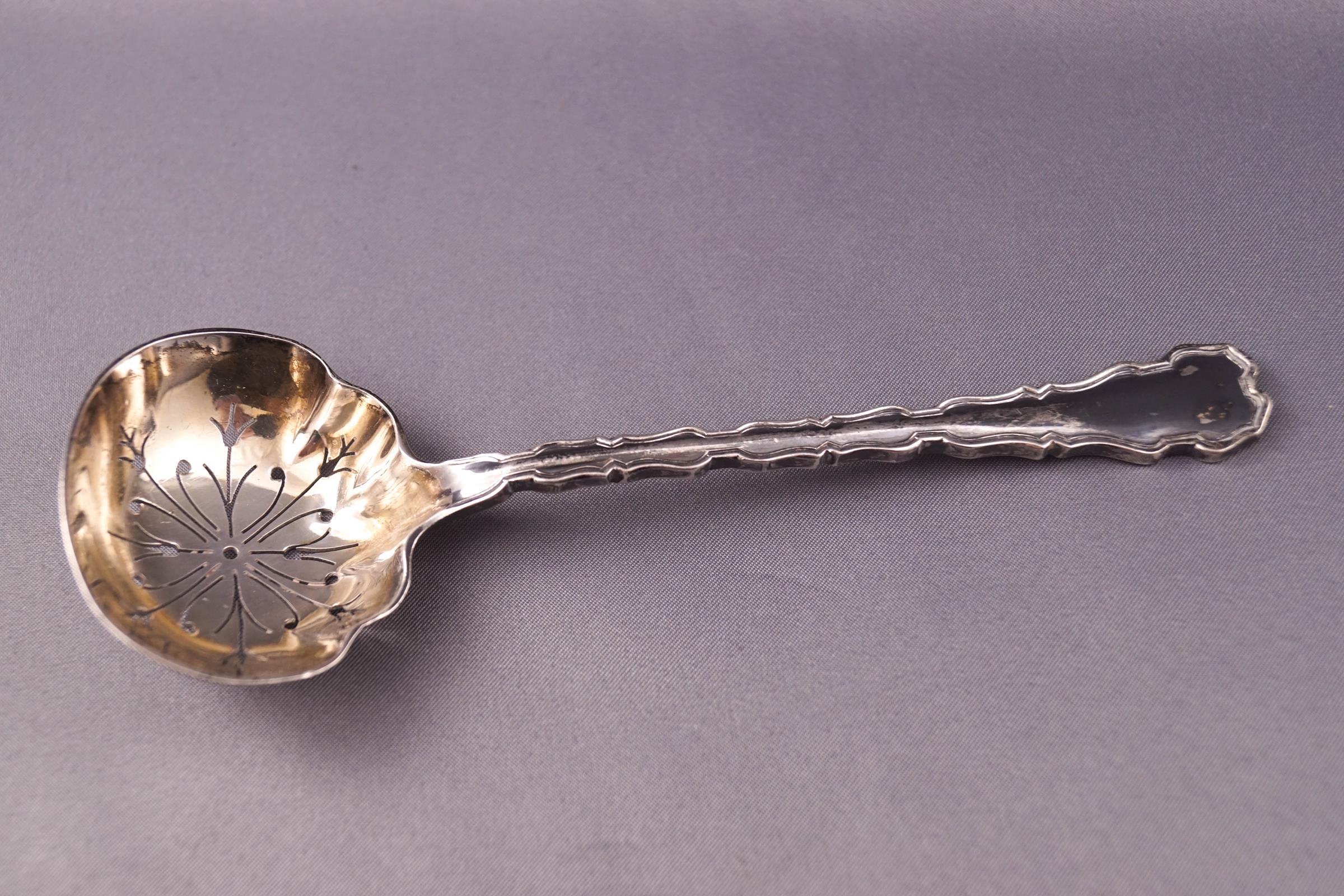 A silver sugar sifter spoon, registration number 394980, Sheffield 1912,