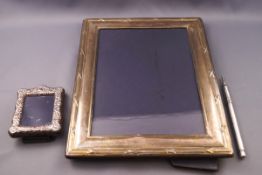A large silver photograph frame with reeded and ribbon band, 25cm x 19.