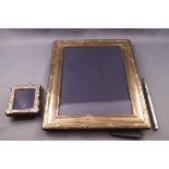 A large silver photograph frame with reeded and ribbon band, 25cm x 19.