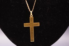 A yellow metal plain cross pendant suspended from a fancy linked chain, Cross stamped 750.