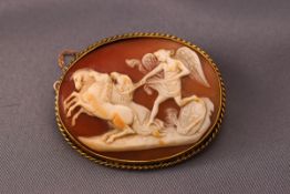 A yellow metal cameo brooch. Base metal in with 9ct mount and safety chain. Weight: 15.
