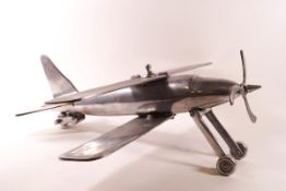 An aluminium model of a plane with retractable wheels,