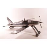 An aluminium model of a plane with retractable wheels,