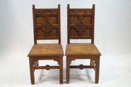 A pair of oak Church chairs with panelled backs,